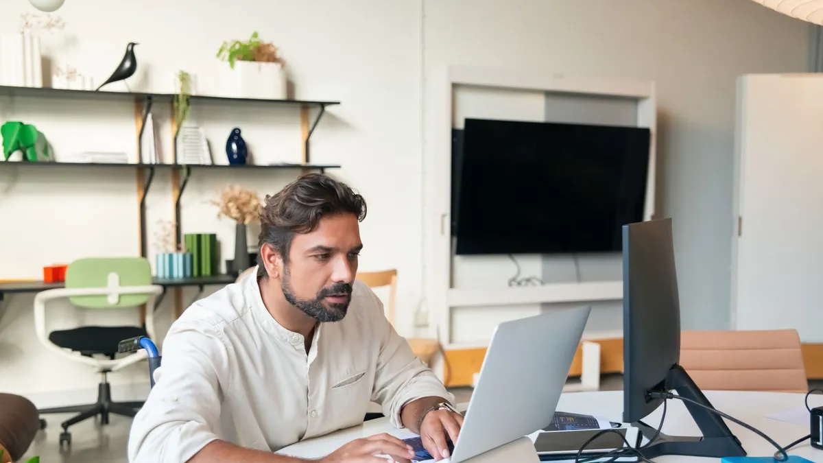 Calm person at a kitchen table reviewing disability loan documents beside a repayment calendar