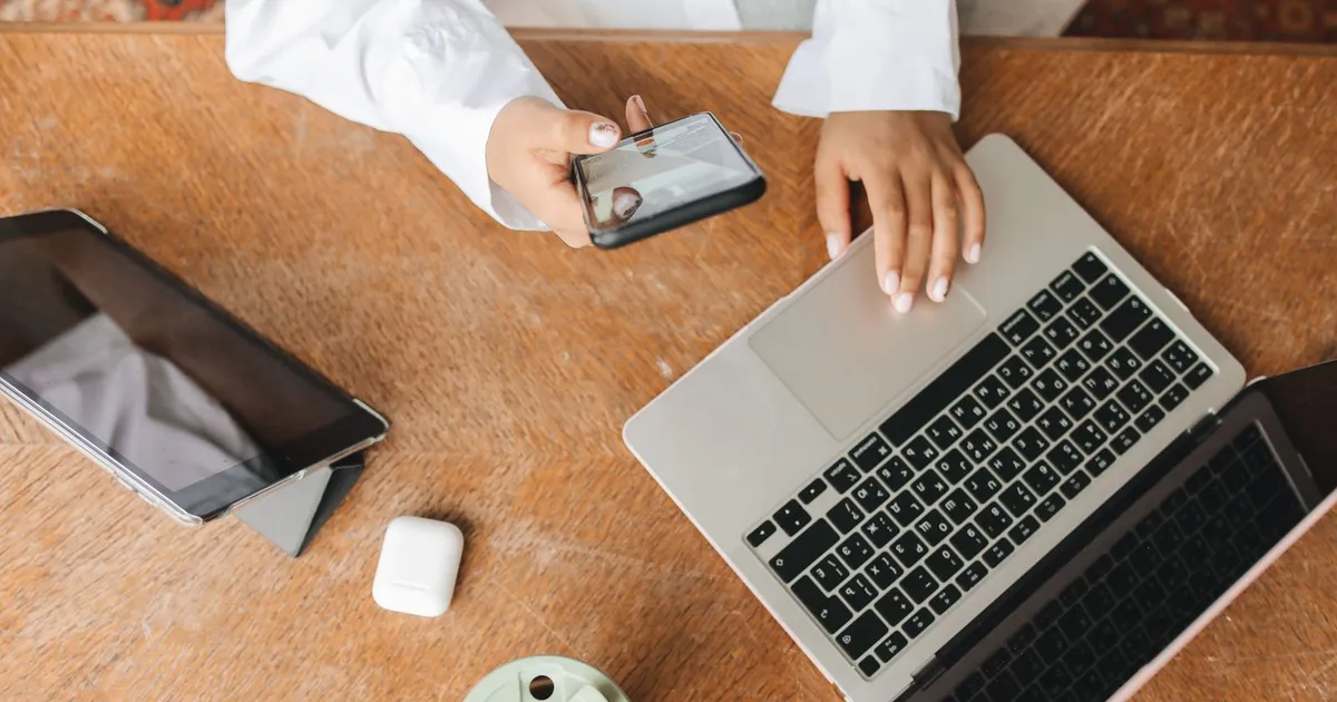 Person comparing the best no credit check loans on a tablet and laptop side by side