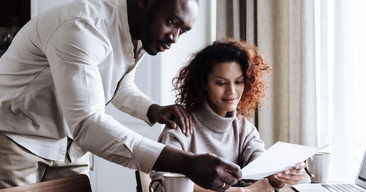 Couple comparing payday loan offers at home to find the best payday loan in Canada