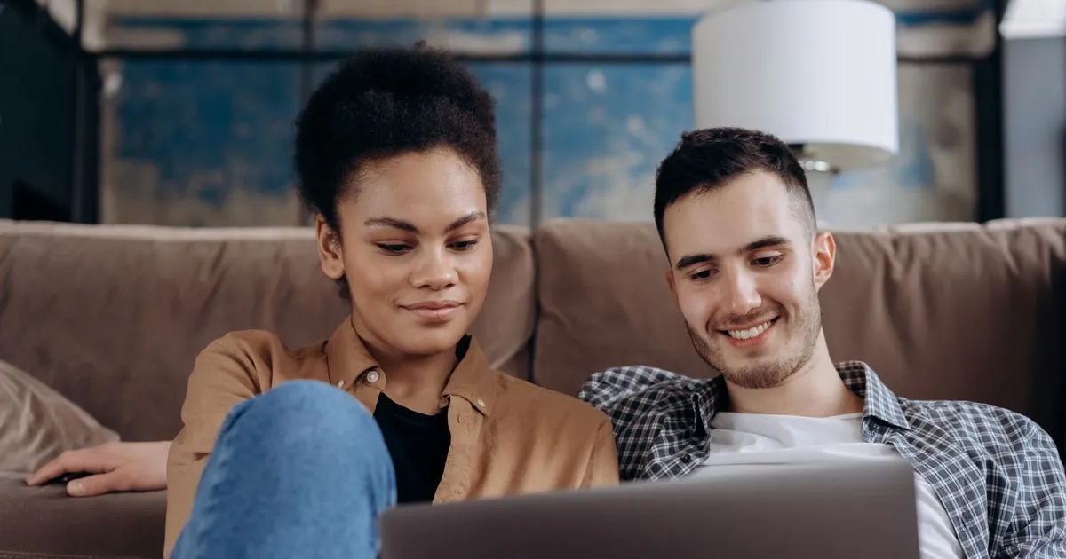 Person working through a checklist to compare guaranteed approval payday loans on a laptop