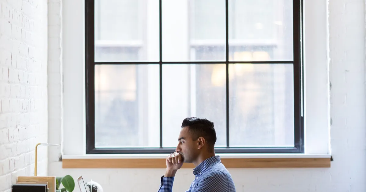 Unemployed man searching for jobs on a laptop while comparing loans unemployed Canadians can get