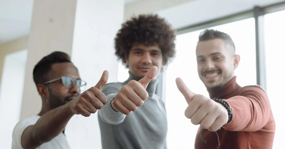 Person smiling at an approval message after comparing no refusal loans on a phone